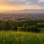 Widok na Kraków z kwiecistej łąki, z Tatrami i Zakopanem w tle o zachodzie słońca
